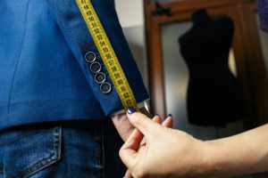 Tailor taking measurements